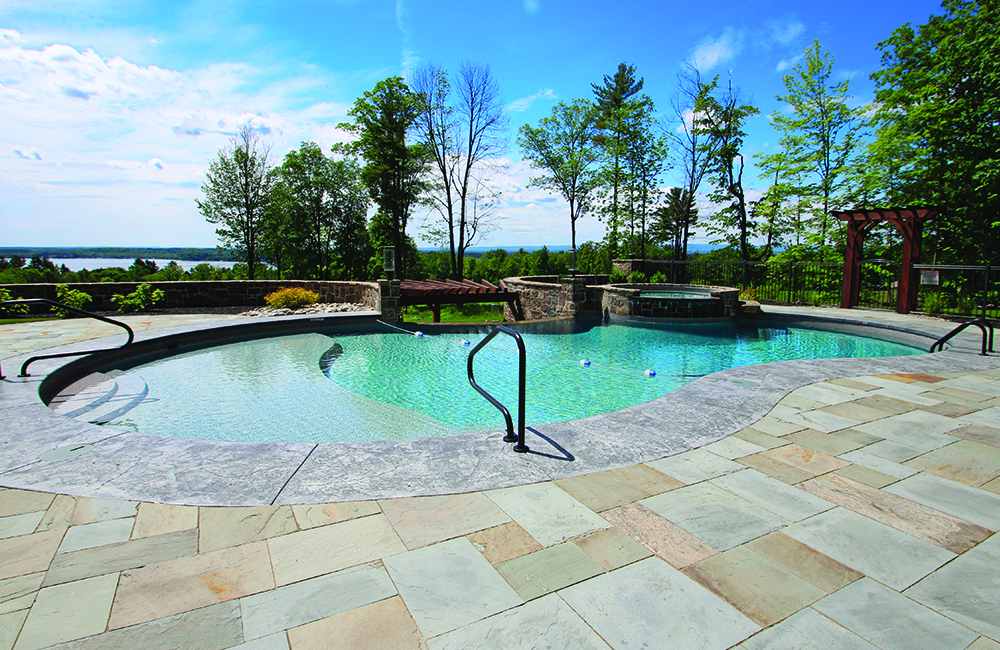 Figure 8 featuring a Wedding Cake Nexus™ Polymer Stair and Sundeck, and Thermoplastic round Poolside Spa